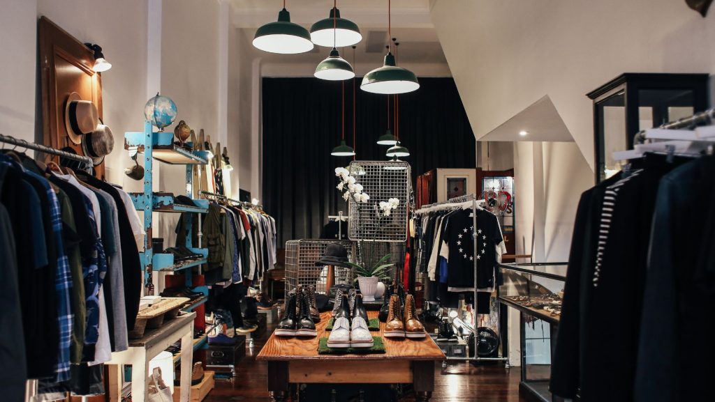 A room with a table with shoes and various clothing products.The Path to Responsible Product Destruction