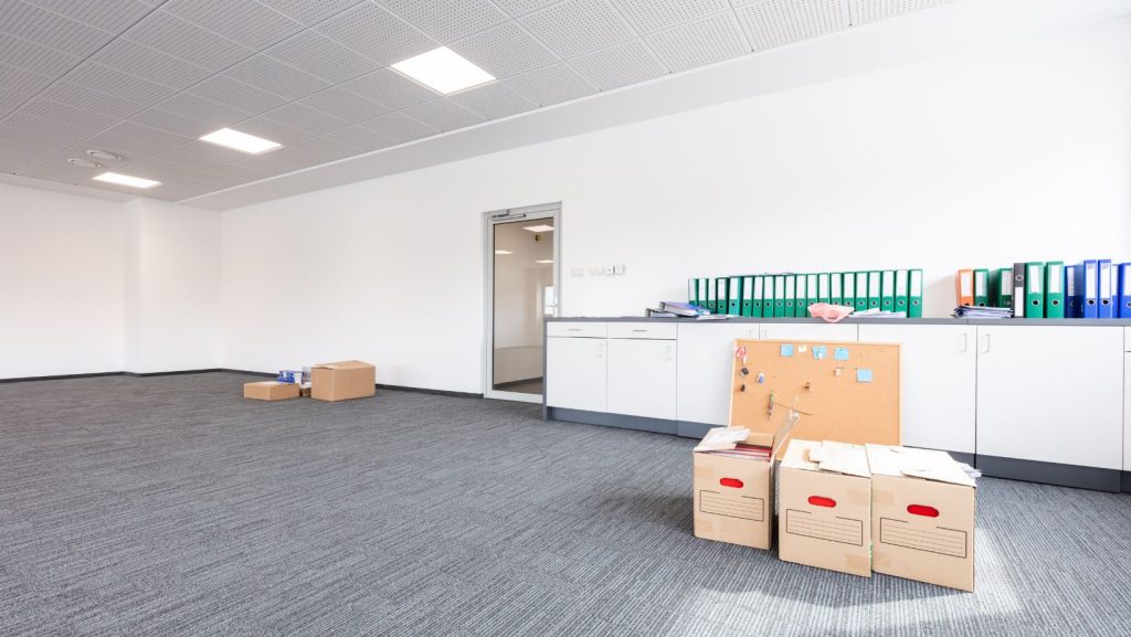 An empty office with moving boxes.